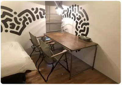 a room with a desk with chairs and a bed at world potential / Vacation STAY 4630 in Tokyo