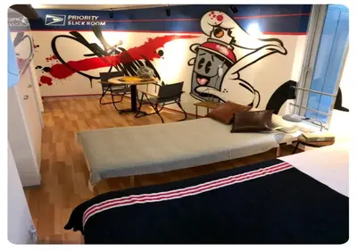 a room with a bed with a painting on the wall at world potential / Vacation STAY 4610 in Tokyo