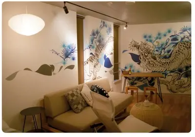 a living room with a couch and blue and white walls at world potential / Vacation STAY 4611 in Tokyo