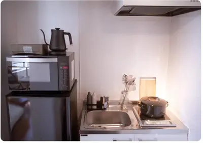 a kitchen counter with a microwave and a sink at world potential / Vacation STAY 4611 in Tokyo