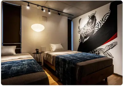 a bedroom with two beds and a painting on the wall at world potential / Vacation STAY 4613 in Tokyo