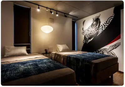 a room with two beds and a painting on the wall at world potential / Vacation STAY 4613 in Tokyo