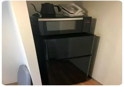 a microwave sitting on top of a black stand at world potential / Vacation STAY 4631 in Tokyo