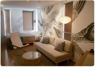a living room with a couch and a bed at world potential / Vacation STAY 4632 in Tokyo