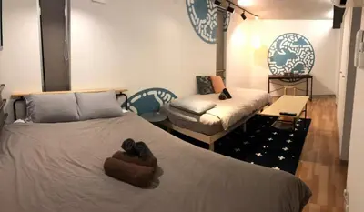 a bedroom with a large bed and a couch at world potential / Vacation STAY 4612 in Tokyo
