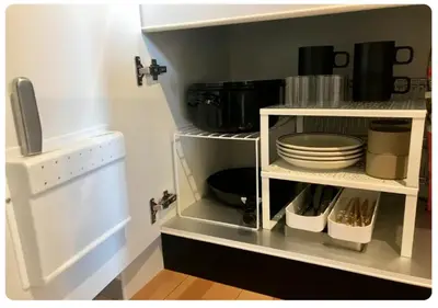a kitchen with a shelf with plates and pans at world potential / Vacation STAY 4612 in Tokyo