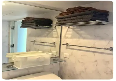 a bathroom with a toilet and a mirror and towels at world potential / Vacation STAY 4612 in Tokyo