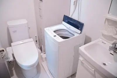 a small bathroom with a toilet and a sink at Laffitte Tokyo in Tokyo