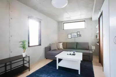 a living room with a couch and a table at Laffitte Tokyo in Tokyo