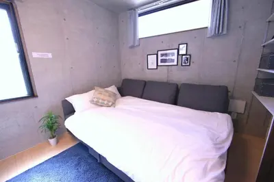 a bedroom with a large white bed with a window at Laffitte Tokyo in Tokyo