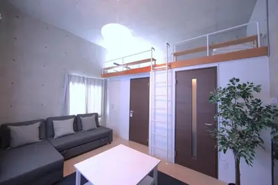 a living room with a couch and a bunk bed at Laffitte Tokyo in Tokyo