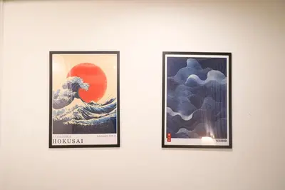 two framed pictures of a tsunami on a wall at \u30e9\u30d5\u30a3\u30c3\u30c8\u5fa1\u5f92\u753a in Tokyo