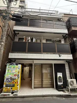 a store front of a building on a street at Tookin house \u6c60\u888b in Tokyo
