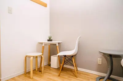 a room with two tables and two stools at Tookin house \u6c60\u888b in Tokyo