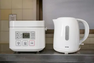a microwave and a coffee maker on a counter at Uhome Akihabara Apartment 3 in Tokyo