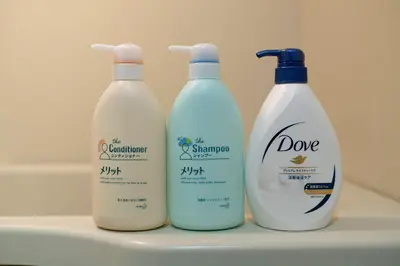 three bottles of milk sitting on top of a sink at Uhome Akihabara Apartment 3 in Tokyo