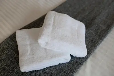 a pile of white towels sitting on the floor at Uhome Akihabara Apartment 3 in Tokyo