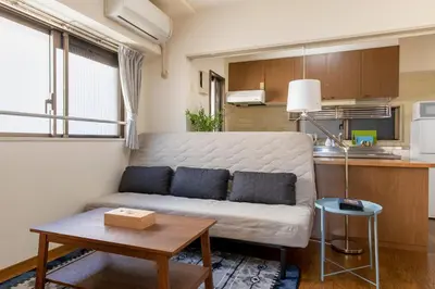 a living room with a couch and a table at Uhome Akihabara Apartment 3 in Tokyo