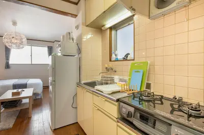 a kitchen with a stove and a refrigerator at Uhome Ueno Apartment 4 in Tokyo