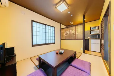 a living room with a table and a couch at YADOYA Sennokaze in Tokyo