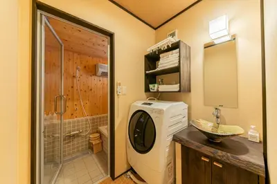 a bathroom with a sink and a washing machine at YADOYA Sennokaze in Tokyo