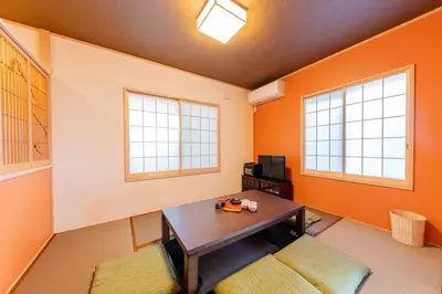 a room with a table and two windows at YADOYA Sennosato in Tokyo
