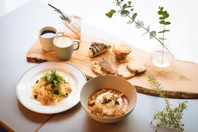 a table with two plates of food and a cutting board at LANDABOUT TOKYO in Tokyo