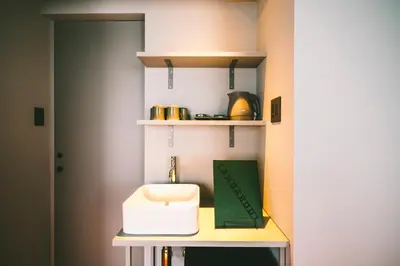 a kitchen with a counter with a toaster on a shelf at LANDABOUT TOKYO in Tokyo