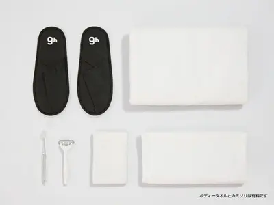 a pair of black slippers and a white towel at 9h nine hours Suidobashi in Tokyo