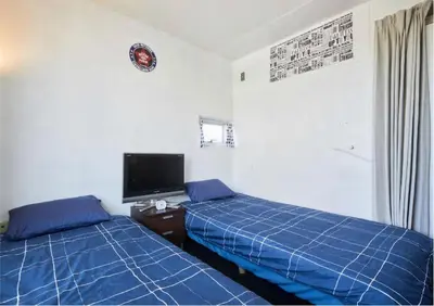 a bedroom with two beds and a tv in it at 2BR 5beds Shibuya Shinjuku Harajuku 10min wifi in Tokyo