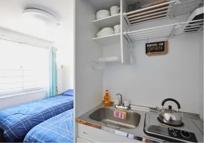a kitchen with a sink next to a sink at 2BR 5beds Shibuya Shinjuku Harajuku 10min wifi in Tokyo
