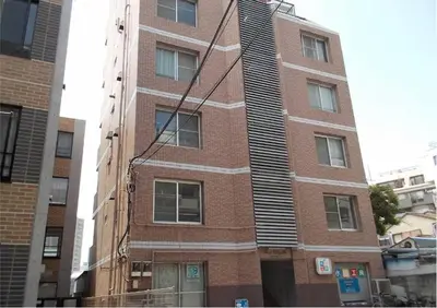 a tall brick building on a city street at 2BR 5beds Shibuya Shinjuku Harajuku 10min wifi in Tokyo