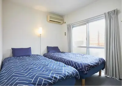 a bedroom with two beds and a window at 2BR 4beds Shibuya Shinjuku Harajuku 10min wifi in Tokyo