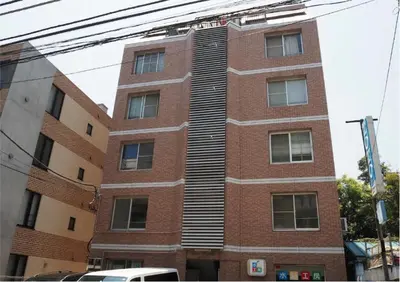 a red brick building with a staircase on the side at 2BR 4beds Shibuya Shinjuku Harajuku 10min wifi in Tokyo