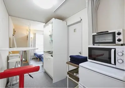 a kitchen with white cabinets and a red stool at 2BR 4beds Shibuya Shinjuku Harajuku 10min wifi in Tokyo