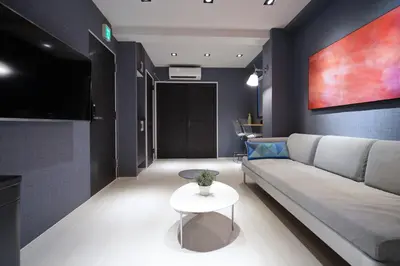 a living room with a couch and a table at Real Life Meguro River in Tokyo