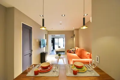 a living room with a table with dishes on it at Real Life Meguro River in Tokyo