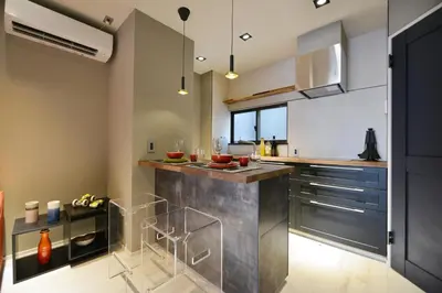 a kitchen with stainless steel countertops and stainless steel appliances at Real Life Meguro River in Tokyo