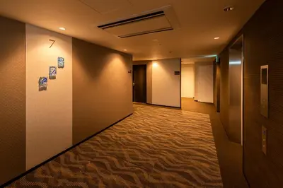 a hallway with a long corridor with a hallway at Shizutetsu Hotel Prezio Tokyo Tamachi in Tokyo