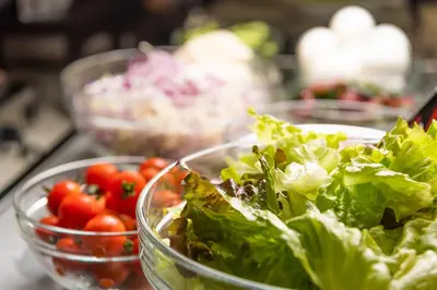 three bowls of lettuce and tomatoes on a table at Shizutetsu Hotel Prezio Tokyo Tamachi in Tokyo
