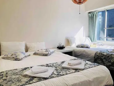 two beds in a room with towels on them at Julian home Shinagawa 5 mins Shibuya 7 mins in Tokyo
