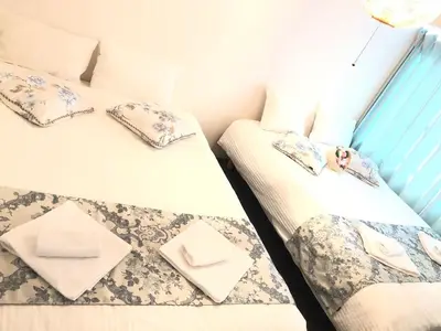 two twin beds in a room with towels on them at Julian home Shinagawa 5 mins Shibuya 7 mins in Tokyo