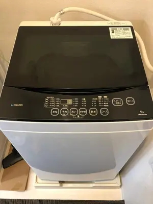 a black and white printer sitting on a stand at Julian home Shinagawa 5 mins Shibuya 7 mins in Tokyo