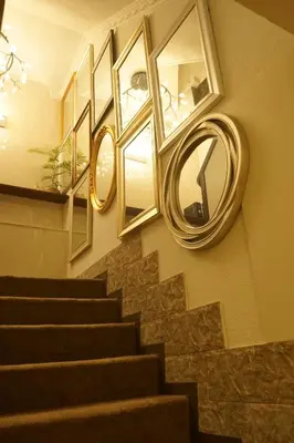 a stairway with a mirror and a staircase with aigunigunigun at Himalaya Cloud Hotel in Tokyo