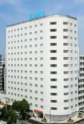 a white building with a sign on top of it at Hotel Lumiere Nishikasai in Tokyo
