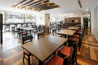 a dining room with tables and chairs and windows at Hotel Lumiere Kasai in Tokyo