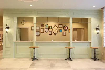 a room with a counter with clocks on the wall at HOTEL EURASIA MAIHAMA ANNEX in Urayasu