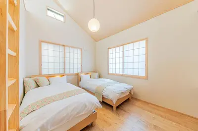 two beds in a room with two windows at Yadoya Asakusa Sennosato / Vacation STAY 46671 in Tokyo