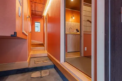 a hallway of a house with an orange wall at Yadoya Asakusa Sennosato / Vacation STAY 46671 in Tokyo