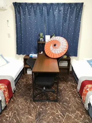 a room with a desk with an orange umbrella on it at ohayo\u672c\u6240 in Tokyo